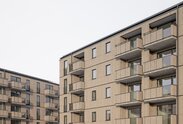 Partial view of the timber façades of two large residential buildings | © Florian Holzherr