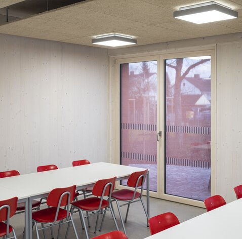 Un angolo di una classe con pareti in legno lamellare incrociato a vista | © Florian Holzherr